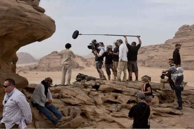 Camera and sound crew on a rock outcrop